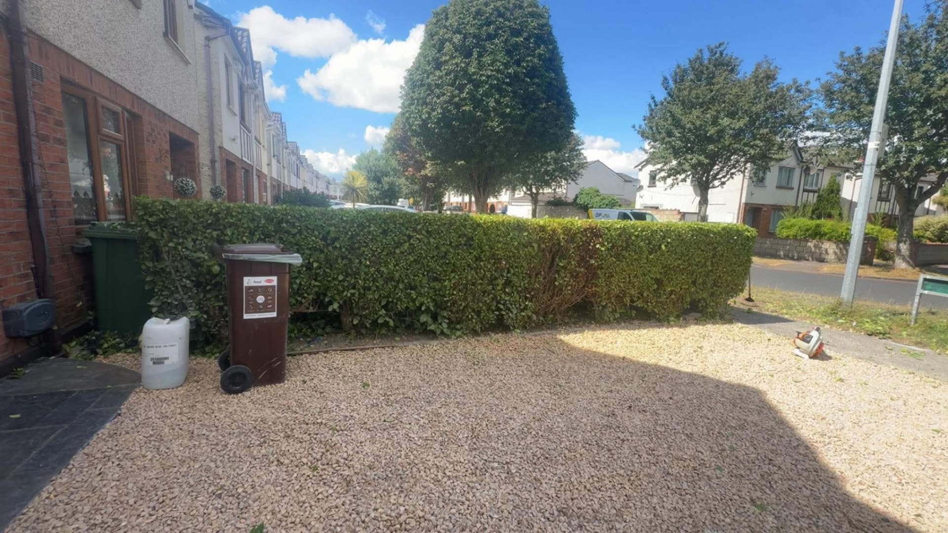 Same front hedge cut back neat, level and square after trimming