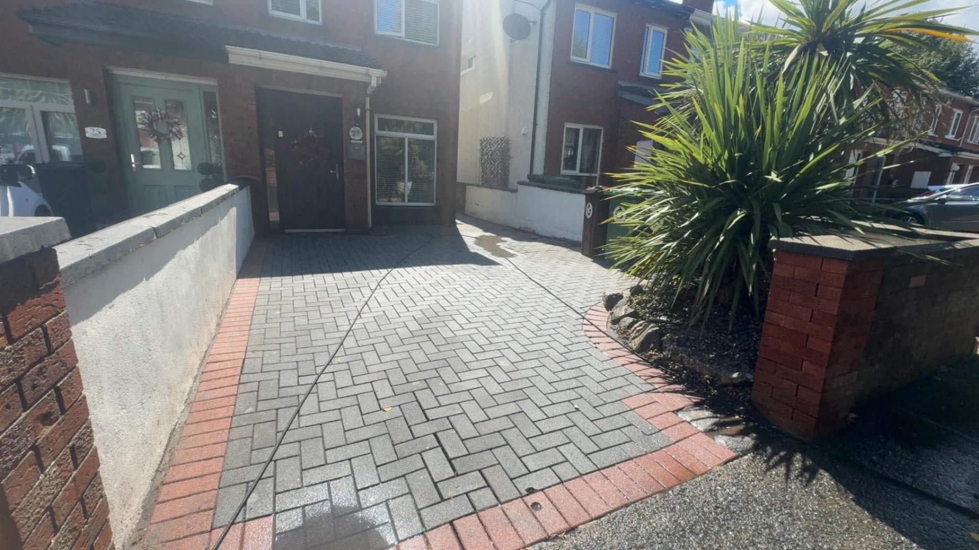 Same herringbone driveway weeded and power washed back to clean paving