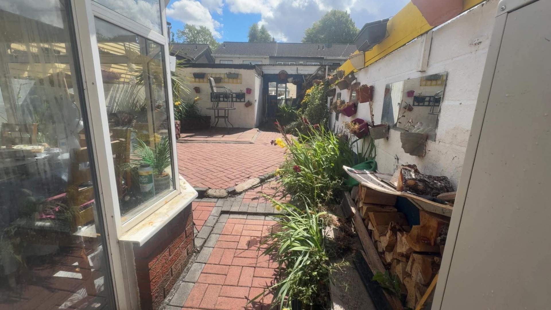 Same courtyard patio cleared, swept and tidy with the beds cut back