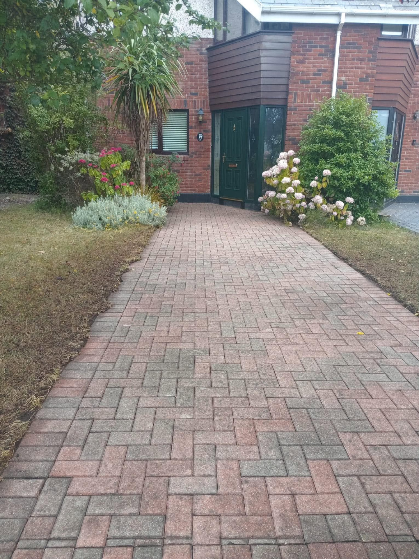 Same brick front path washed clean and back to its original red colour